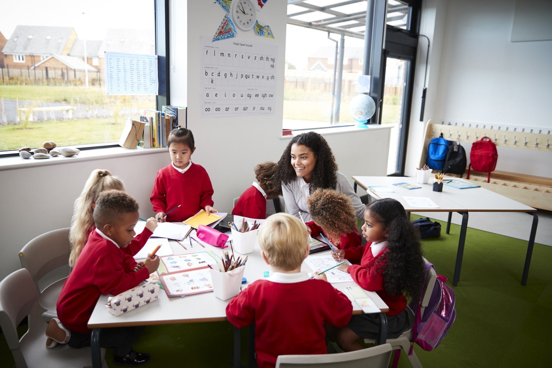 a-group-of-infant-school-kids-sitting-at-a-table-i-2024-10-19-13-03-52-utc